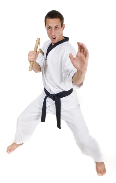 Молодой человек в белом кимоно с нунчаком — стоковое фото