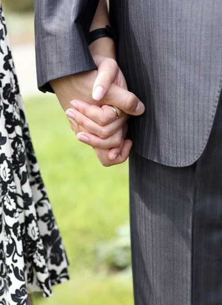 Close-up on young man and woman hands ho — Stock Photo, Image