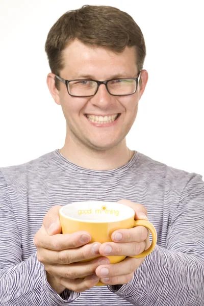 Man with yellow cup (focus on cup) — Stock Photo, Image