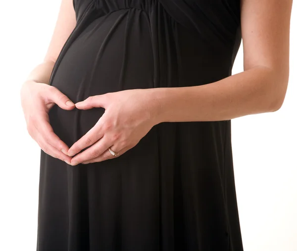 Barriga de mulher grávida em vestido preto — Fotografia de Stock