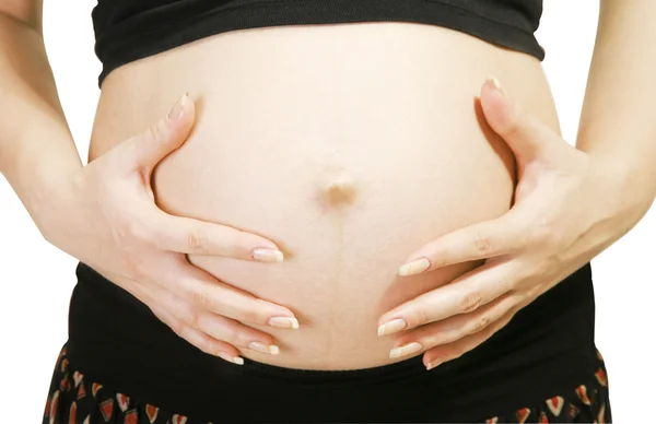 Närbild på gravid kvinna anläggningen — Stockfoto