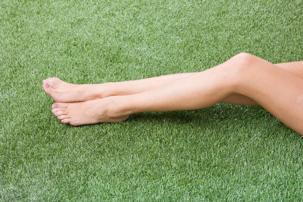 Beautiful slim female feet on grass Stock Photo by ©svyatoslavlipik 1362064