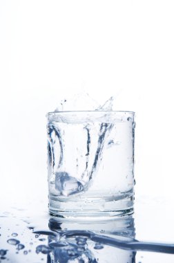 Glass of splashing water clipart