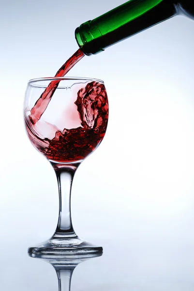 Bir bardak kırmızı şarap dökün — Stok fotoğraf
