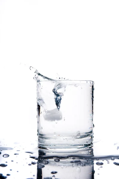 Glass of splashing water — Stock Photo, Image
