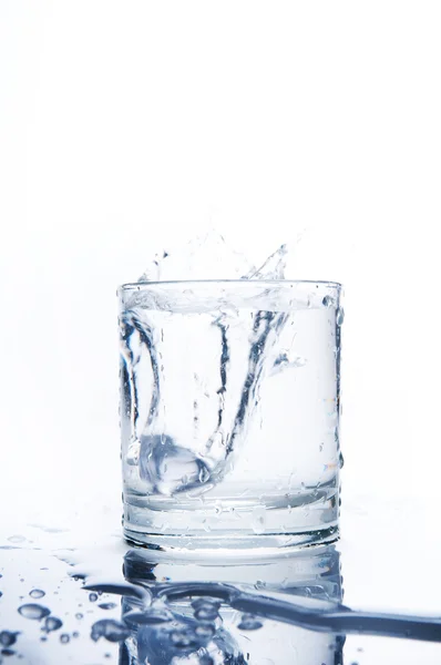 Glass of splashing water — Stock Photo, Image