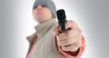 Young man is aiming with gun clipart