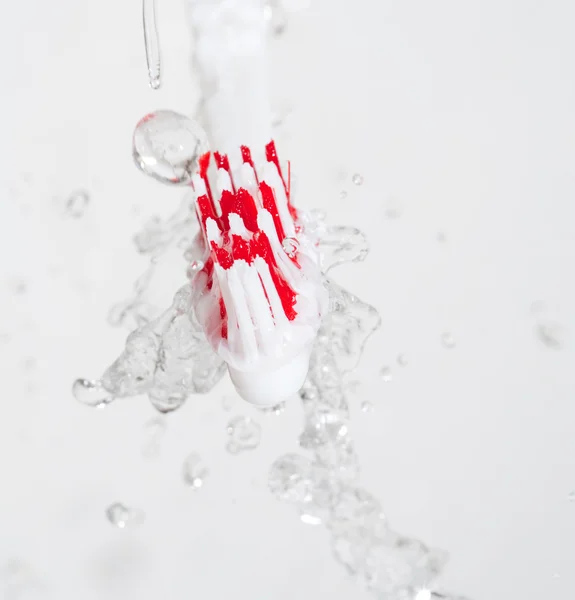 Toothbrush in a water splash — Stock Photo, Image