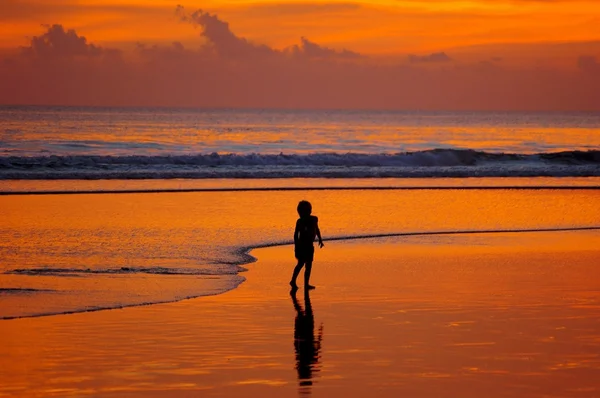 stock image Boy on beach at sunset