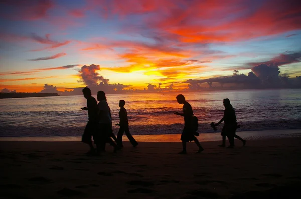 stock image Walking on the beach at sunset