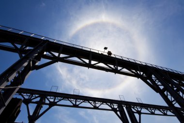 Amazing sun halo above bridge clipart