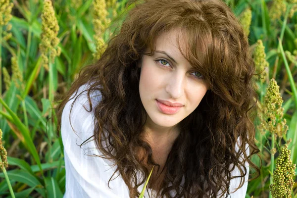 Woman in the field with wavy hair — Stock Photo, Image