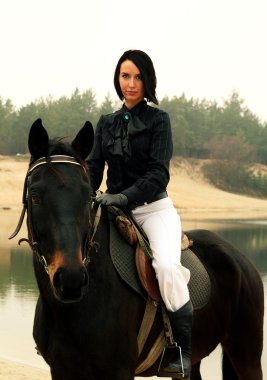 Beautiful elegant woman riding a horse clipart