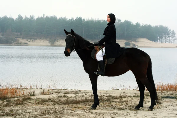 Beautiful elegant woman riding a horse — Stock Photo, Image
