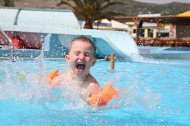 The child laps in an aquapark. clipart
