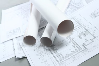 Rolls of the drawings for construction of a house clipart