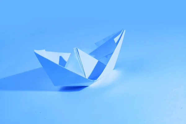 Paper boat isolated on blue — Stock Photo, Image