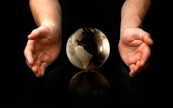 Isolated hands around of globe — Stock Photo, Image