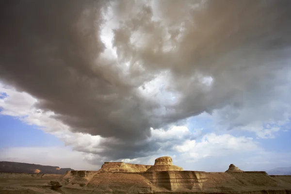 Huge cloud above stone desert.