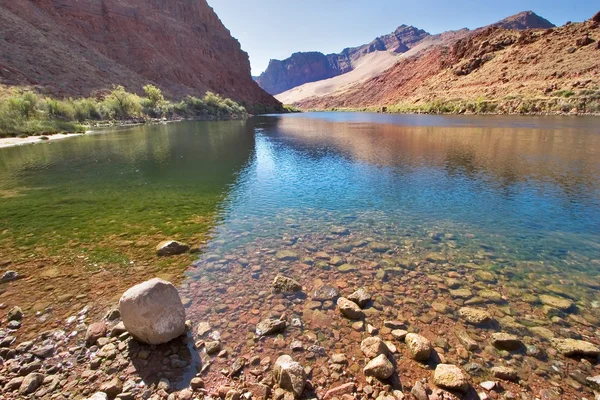 Stock image Multi-coloured water in the river.