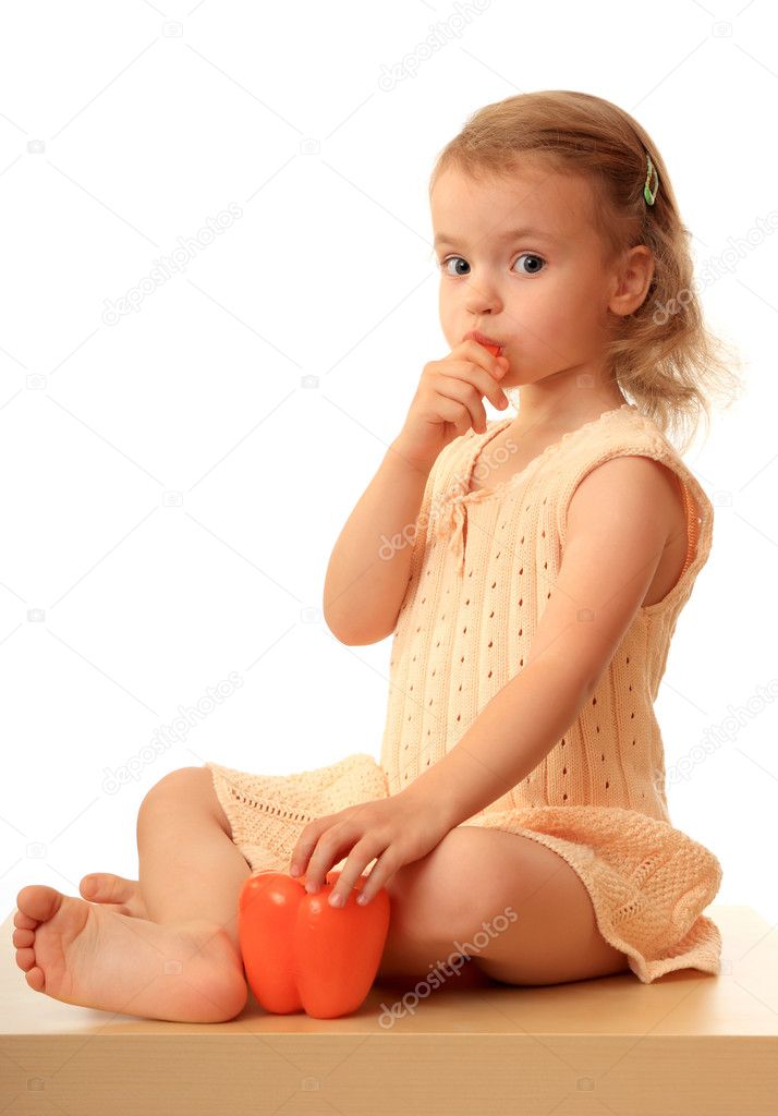 Girl eats a sweet pepper.