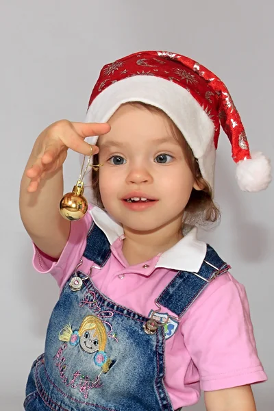 A girl is in a new-year cap. — Stock Photo, Image