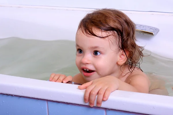 A little girl bathes. Stock Photo