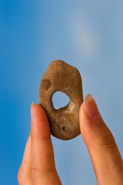 Hand with holey stone clipart