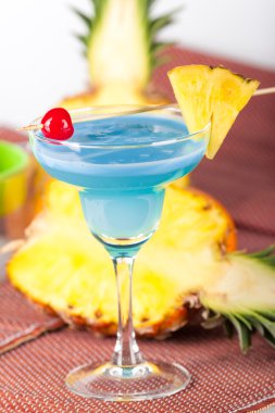 Blue alcohol cocktail with cherry clipart