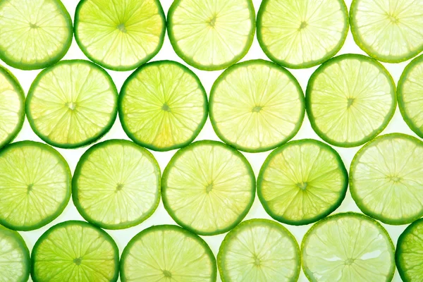 Fatias de limão verde fundo — Fotografia de Stock
