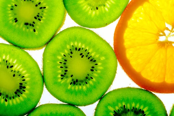 Green kiwi with one orange slice — Stock Photo, Image
