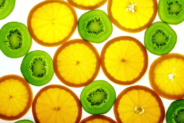 Green kiwi and orange slices — Stock Photo, Image