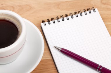 Espresso cup with blank notepad and pen clipart