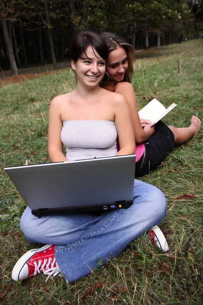 stock image Girls with laptop and book