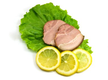 Sliced ham on leaves of salad with a lem clipart