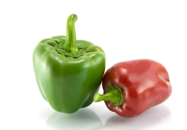 Red and green sweet pepper on a white ba — Stock Photo, Image