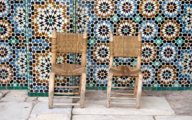 Two chairs on tiles background clipart