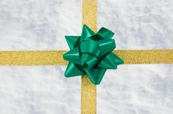 stock image Snow gift with golden ribbon