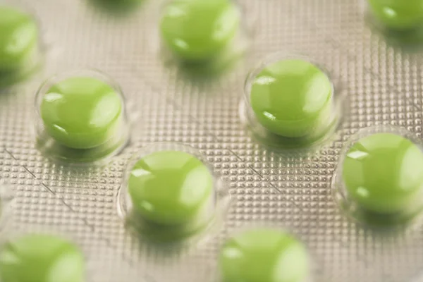 Zblízka zelené pilulky — Stock fotografie