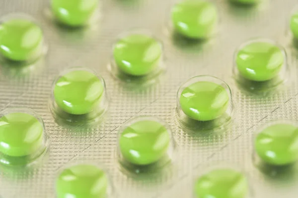 Zblízka zelené pilulky — Stock fotografie