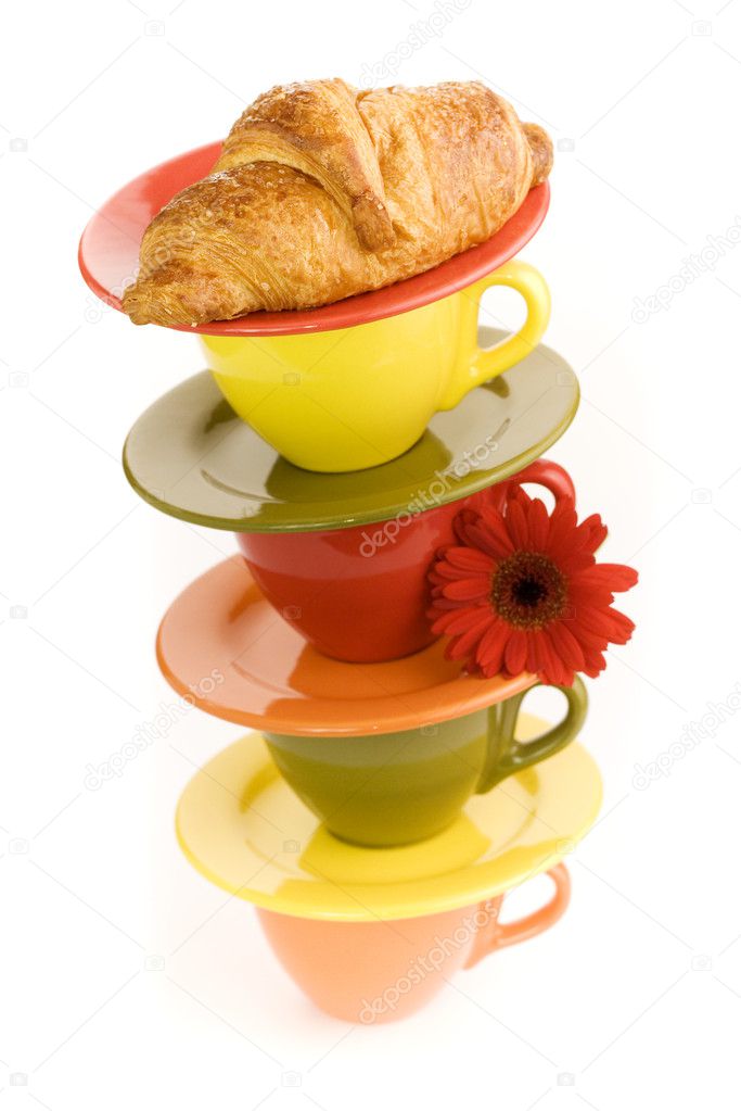 Color cups and fresh croissant