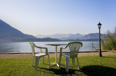 Rest area on the swiss mountains lake clipart