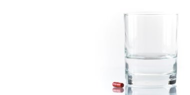 Close up of red pill and water clipart