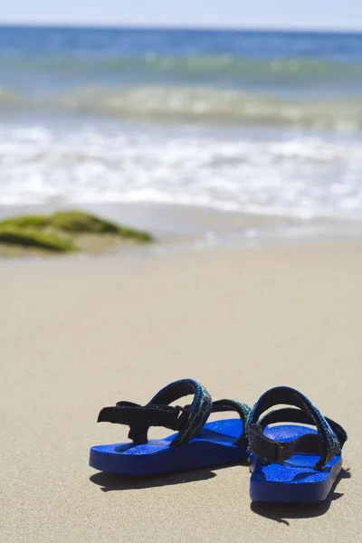 Un par de sandalias en una playa tropical — Foto de Stock