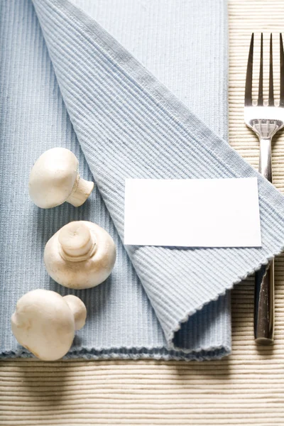 Fork and mushrooms on blue napkin — Stock Photo, Image