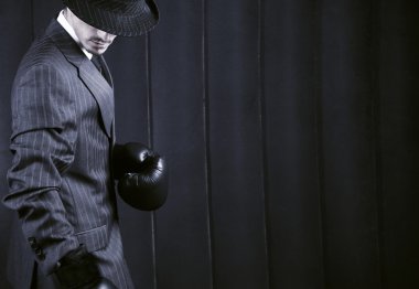 Gangster in grey suit in boxing gloves clipart