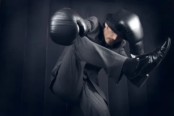 Freakish fighter in a grey suit — Stock Photo, Image