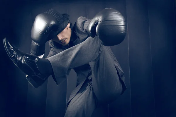 Freakish fighter in a grey suit — Stock Photo, Image