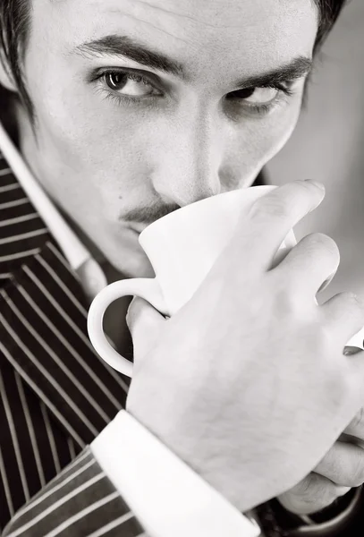 Young macho in striped suit with cup — Stock Photo, Image