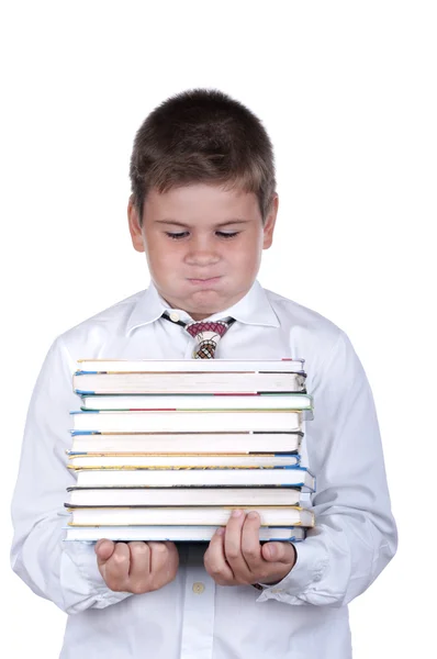 Хлопчик тримає в руках важких книжок — стокове фото